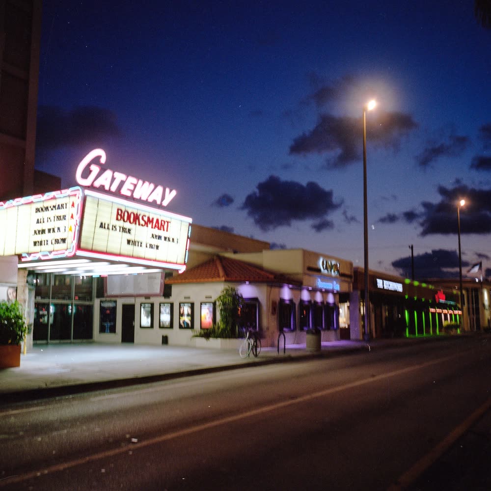 A cinema marquee lit up at dusk