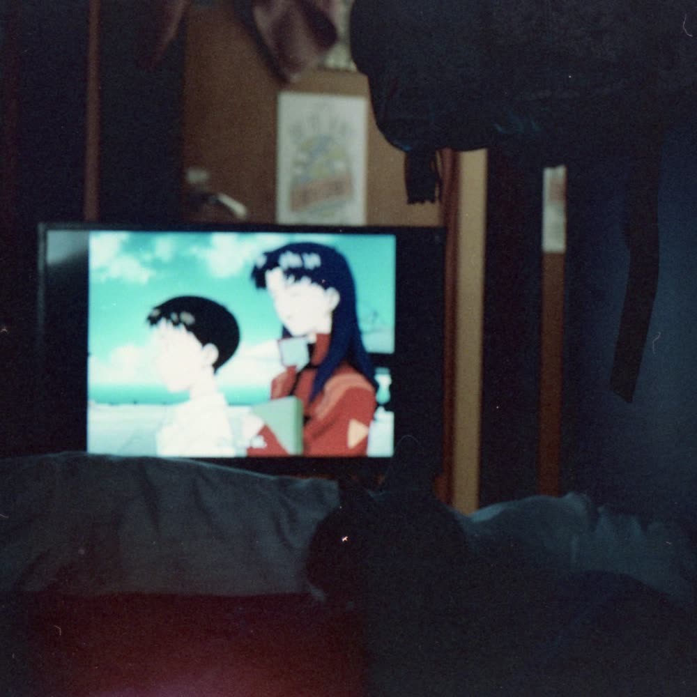 An anime on a small TV in a dark room
